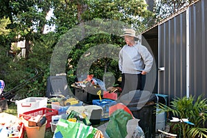 Man cleaning out shed