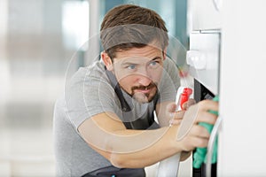 man cleaning oven