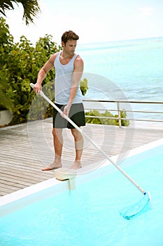 Man cleaning private pool