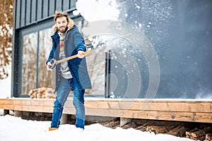 Man cleaning snow near the house