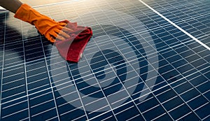 Man cleaning solar panel on roof. Solar panel or photovoltaic module maintenance. Sustainable resource and renewable energy for go