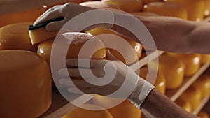 Man cleaning with sponge surface of cheese head