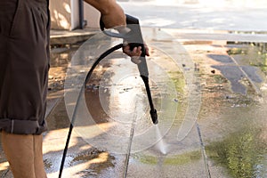 Man cleaning stone with high pressure water jet