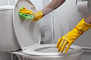 Man cleaning a white WC closeup