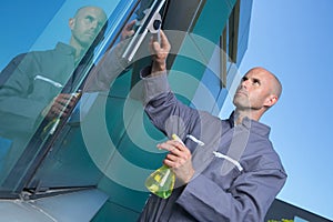 man cleaning window