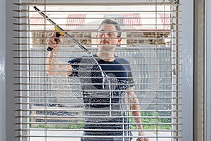 Man cleaning window of a house