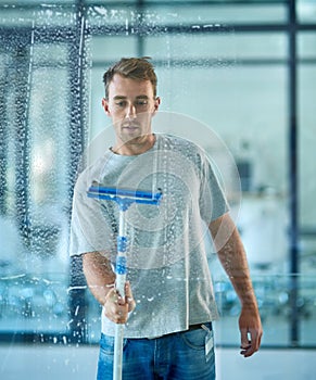 Man, cleaning and window in office building as janitor with squeegee tool for hygiene service, glass or bacteria. Male