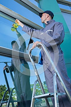 Man cleaning window ouside office