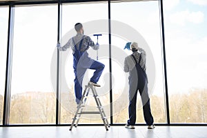 A man cleaning windows. cleaning team of men washes the windows