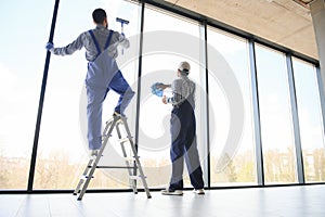 A man cleaning windows. cleaning team of men washes the windows