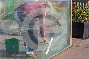 Man cleaning windows glass pane with foam photo