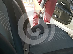Man cleans car interior photo