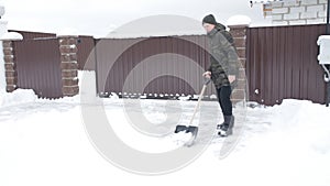 Man cleans the road from the snow