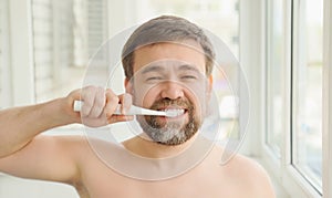 Man cleans teeth electric toothbrush