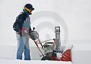 Man clearing driveway with Snowblower