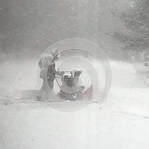 Man Clearing Snow During a Blizzard