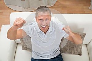 Man Clenching Fist On Sofa