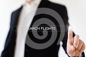 man clicks on the search icon in the line that says search flights.