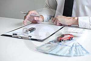 Man client calculating insurance premium for decide signing rental contract form of renting a vehicle agreement, car insurance