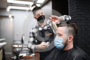 Man client visiting haidresser in barber shop, coronavirus and new normal concept.