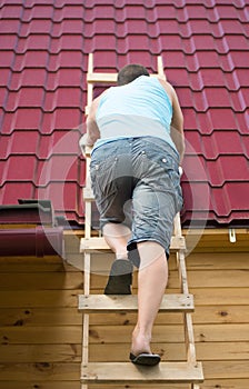 The man climbed the stairs to check the roof of the house after the hurricane