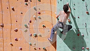 Man climber is climbing on the outdoors climbing gym