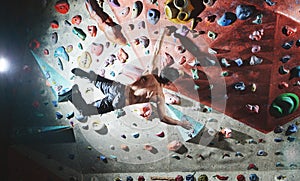 Man climber climbs indoors