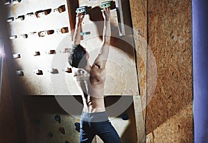 Man climber climbs indoors
