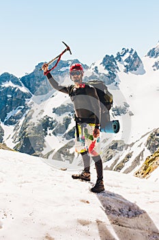 Man climber holding an ice ax on the mountain Traveling Adventure