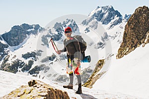 Man climber holding ice axe on mountain Travel Lifestyle