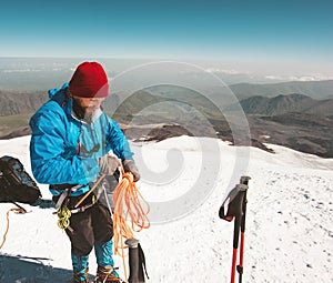 Man climber holding rope climbing equipment