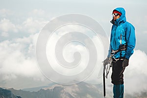 Man climber with ice axe standing on mountain