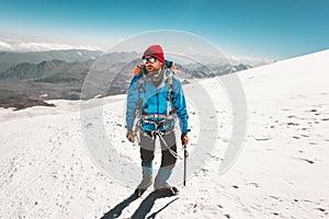 Man climber mountaineering with ice axe in mountains