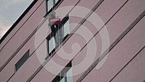 Man climber prepares for cleaning windows