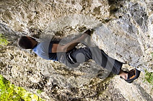 Man climbing a boulder