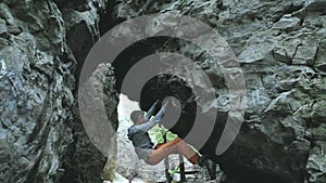 Man climbing bouldering route on the cliff