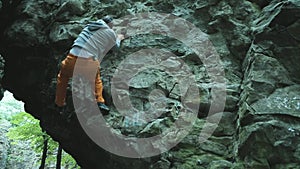 Man climbing bouldering route on the cliff