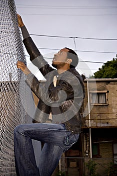 Man climbing city fence