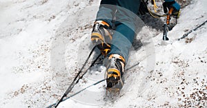 Man is climbing with crampons on the glacier.