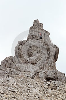 Man climbing free solo a mountain rock in Brenta Dolomites, Italy