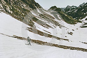 Man climbing in mountains Travel survival lifestyle