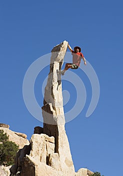 Man Climbing Rock Spire photo