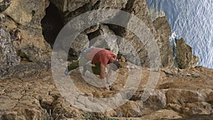 A man is climbing a rock wall