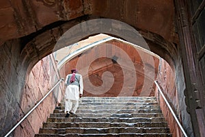 Man climbing stairs of Humayun`s Tomb, in Delhi, India.