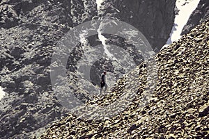man climbing steep mountain. Good image for adventure, struggle and success story photo