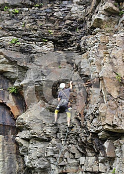 A man climbing up a mountain wall in Bad Gastein