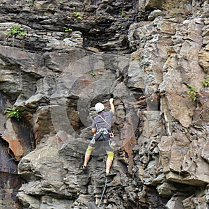 A man climbing up a mountain wall in Bad Gastein