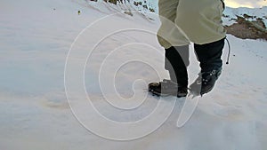 Man Climbing Up Snowy Mountain Ice Axe and Crampons