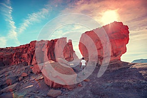 A man climbs on a rock. Desert natural landscape