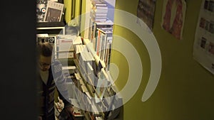 A man climbs the stairs. Multicam, modern space, bookstore, library.